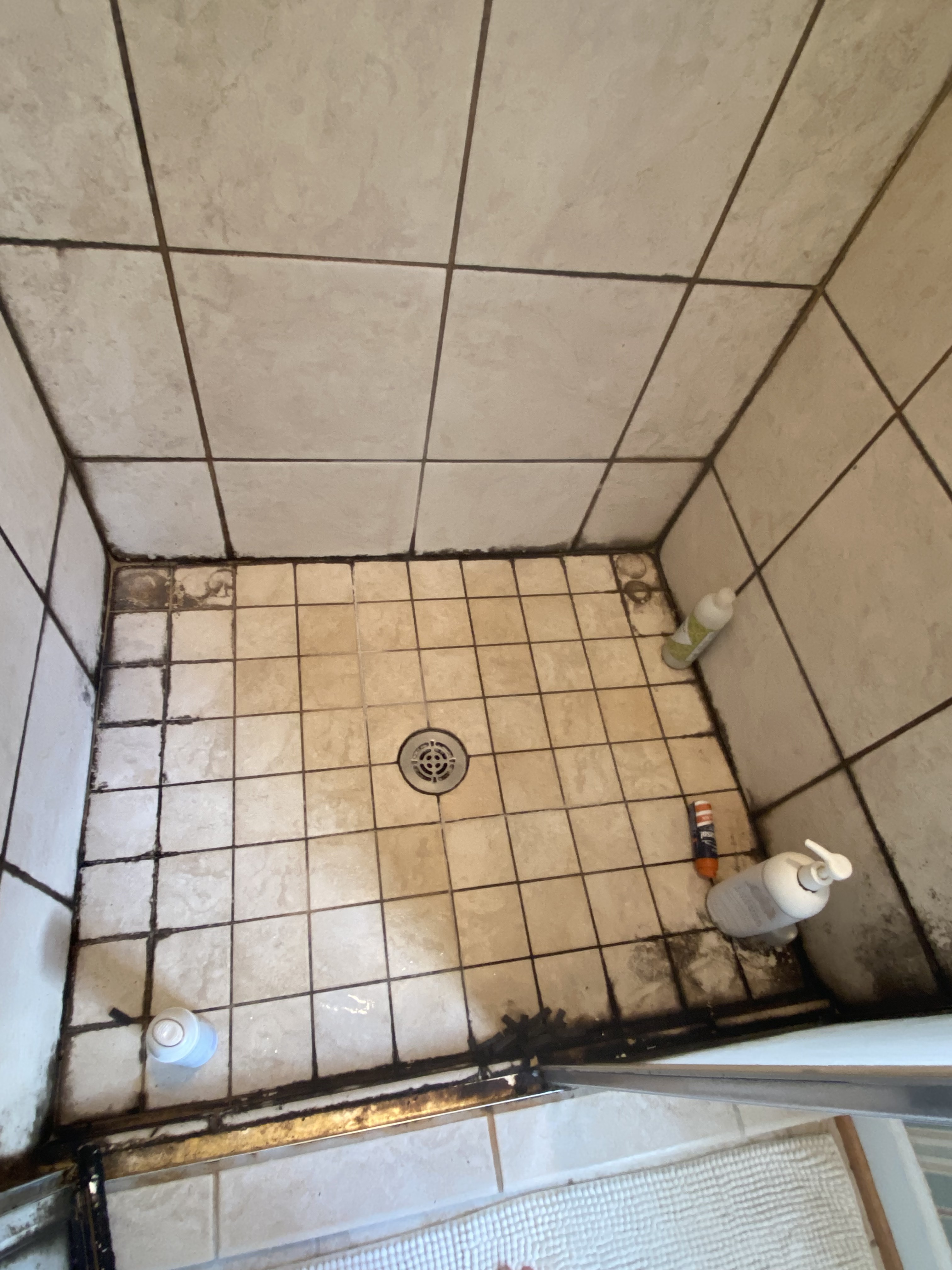 Before shower tile cleaning by All American Cleaning Services